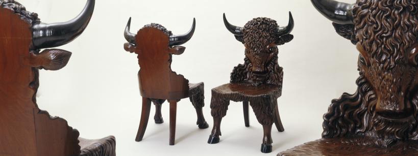 Two Wood Chairs with Carved Buffalo Backs