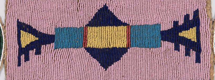 Rectangular beaded strip with geometric patterns in blue, dark blue, yellow, and red beads on a pink background; diagonal blue and dark blue bands border the top and bottom edges.