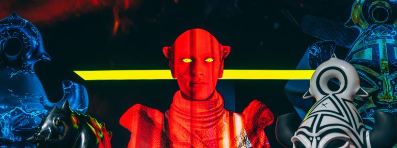 Red person with yellow eyes yellow line behind him, bottom right bust in black and white, other figures in black background